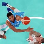 Greece small forward Giannis Antetokounmpo (34) shoots the ball against Germany point guard Isaac Bonga (left) and power forward Daniel Theis (right) during a menís basketball quarterfinal game during the Paris 2024 Olympic Summer Games at Accor Arena.