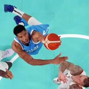 Greece small forward Giannis Antetokounmpo (34) shoots the ball against Germany point guard Isaac Bonga (left) and power forward Daniel Theis (right) during a menís basketball quarterfinal game during the Paris 2024 Olympic Summer Games at Accor Arena.