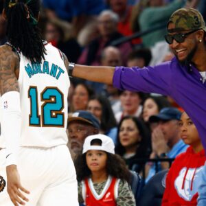 Apr 18, 2025; Memphis, Tennessee, USA; Memphis Grizzlies guard Ja Morant (12) reacts with his father, Tee Morant during the fourth quarter against the Dallas Mavericks at FedExForum.