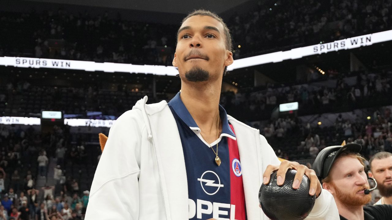 San Antonio Spurs center Victor Wembanyama (1) prepares to throw a ball in to the stands in celebration of Fan Appreciation Day after a victory over the Toronto Raptors at Frost Bank Center.