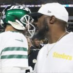New York Jets quarterback Aaron Rodgers (8) and Pittsburgh Steelers head coach Mike Tomlin (right) greet each other after their game at Acrisure Stadium.