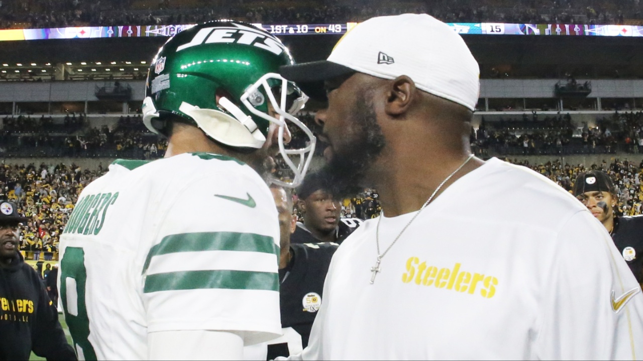 New York Jets quarterback Aaron Rodgers (8) and Pittsburgh Steelers head coach Mike Tomlin (right) greet each other after their game at Acrisure Stadium.
