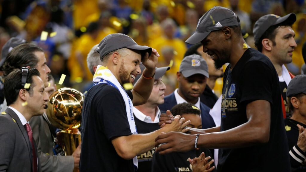 The Golden State Warriors Stephen Curry and Kevin Durant, right, celebrate after defeating the Cleveland Cavaliers, 129-120, in Game 5 of the NBA Finals at Oracle Arena in Oakland, Calif.