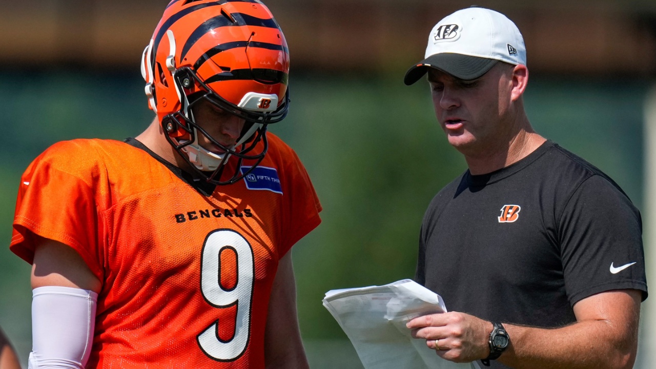 Cincinnati Bengals quarterback Joe Burrow (9) talks with head coach Zac Taylor during a preseason training camp practice in downtown Cincinnati on Wednesday, July 30, 2025.