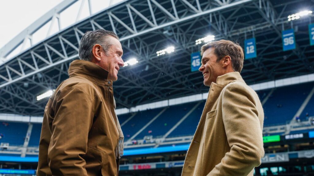 Former New England Patriots quarterbacks Drew Bledsoe, left, and Tom Brady, right, talk during pregame warmups between the Seattle Seahawks and Buffalo Bills at Lumen Field.