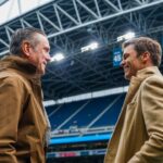 Former New England Patriots quarterbacks Drew Bledsoe, left, and Tom Brady, right, talk during pregame warmups between the Seattle Seahawks and Buffalo Bills at Lumen Field.