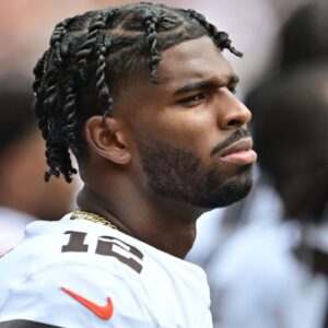 Cleveland Browns quarterback Shedeur Sanders (12) listens to the national anthem before the game between the Browns and the Los Angeles Rams at Huntington Bank Field.