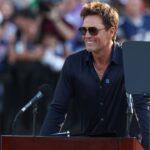 Retired New England Patriot Hall of Famer Tom Brady speaks during a statue unveiling before a game against the Washington Commanders at Gillette Stadium.