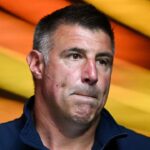 New England Patriots head coach Mike Vrabel walks onto the field before a game against the Washington Commanders at Gillette Stadium.
