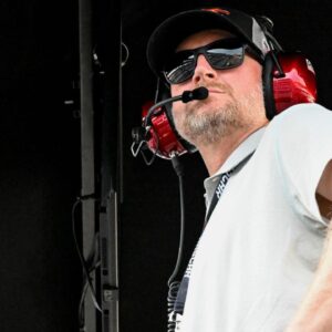 Dale Earnhardt Jr. looks out from his pit box Saturday, July 26, 2025, during the Pennzoil 250 at Indianapolis Motor Speedway.
