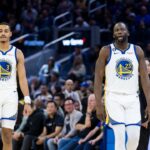 Golden State Warriors guard Jordan Poole (3) and forward Draymond Green (23) return to the court after a time-out taken by the Denver Nuggets during the first half at Chase Center.