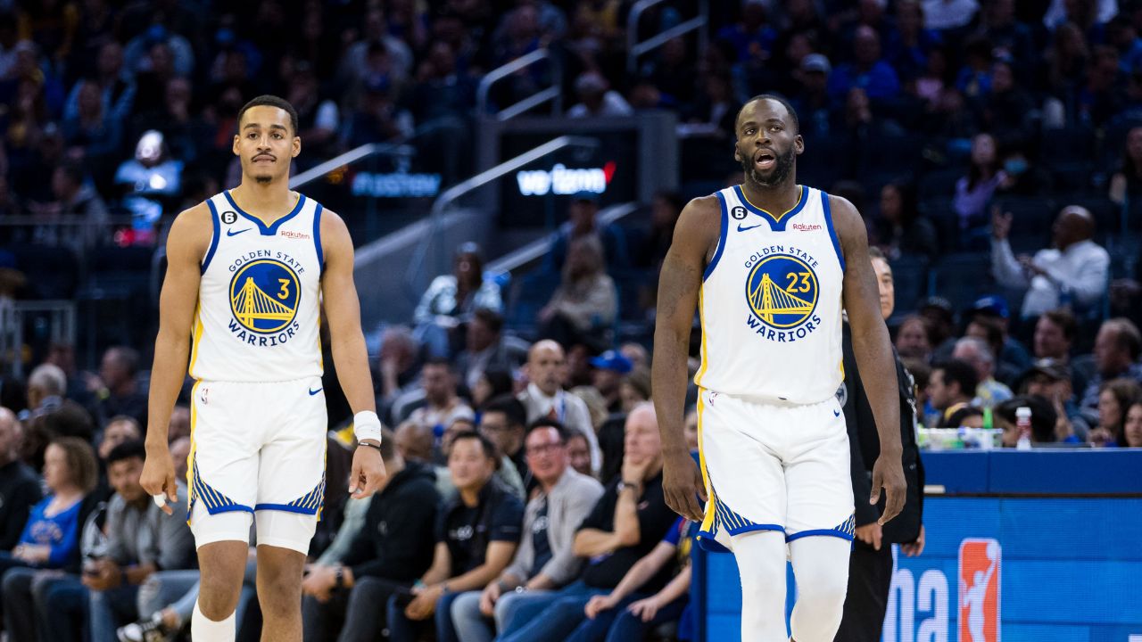 Golden State Warriors guard Jordan Poole (3) and forward Draymond Green (23) return to the court after a time-out taken by the Denver Nuggets during the first half at Chase Center.