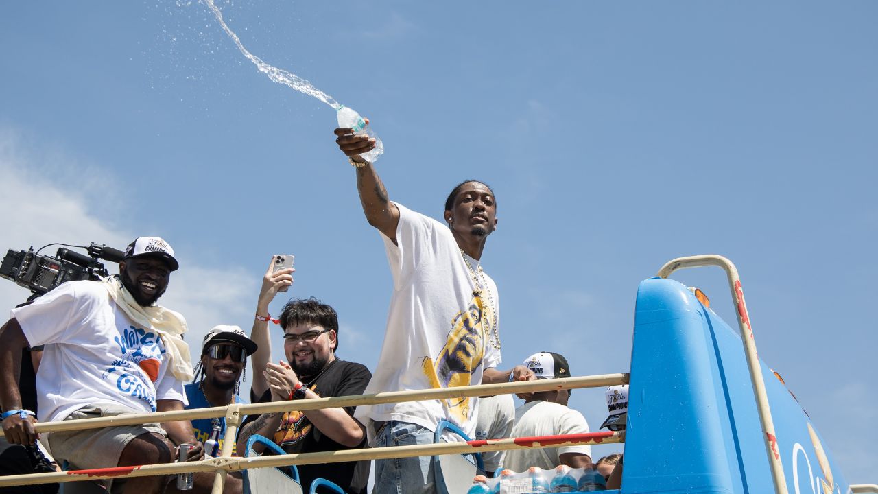 Oklahoma City Thunder player Jalen Williams splashes water on fans during the 2025 NBA Oklahoma City Thunder championship parade