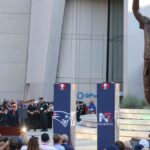 Retired New England Patriot Hall of Famer Tom Brady speaks during a statue unveiling before a game against the Washington Commanders at Gillette Stadium.