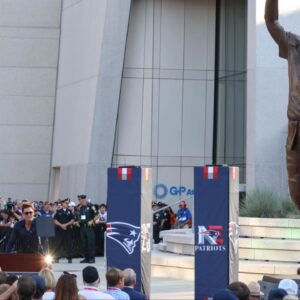 Retired New England Patriot Hall of Famer Tom Brady speaks during a statue unveiling before a game against the Washington Commanders at Gillette Stadium.