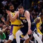 Denver Nuggets center Nikola Jokic (15) controls the ball as Los Angeles Lakers forward Markieff Morris (88) guards in the third quarter at Ball Arena.