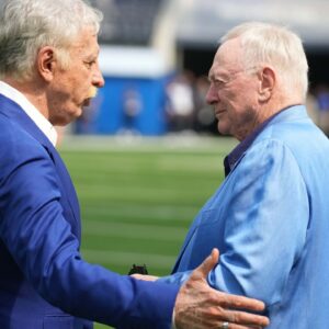 Los Angeles Rams owner Stan Kroenke (left) talks with Dallas Cowboys owner Jerry Jones during the game at SoFi Stadium.