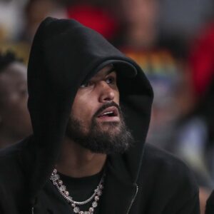 Jun 27, 2025; College Park, Georgia, USA; Atlanta Hawks player Trae Young watches the game between the Atlanta Dream against the Minnesota Lynx during the first half at Gateway Center Arena at College Park