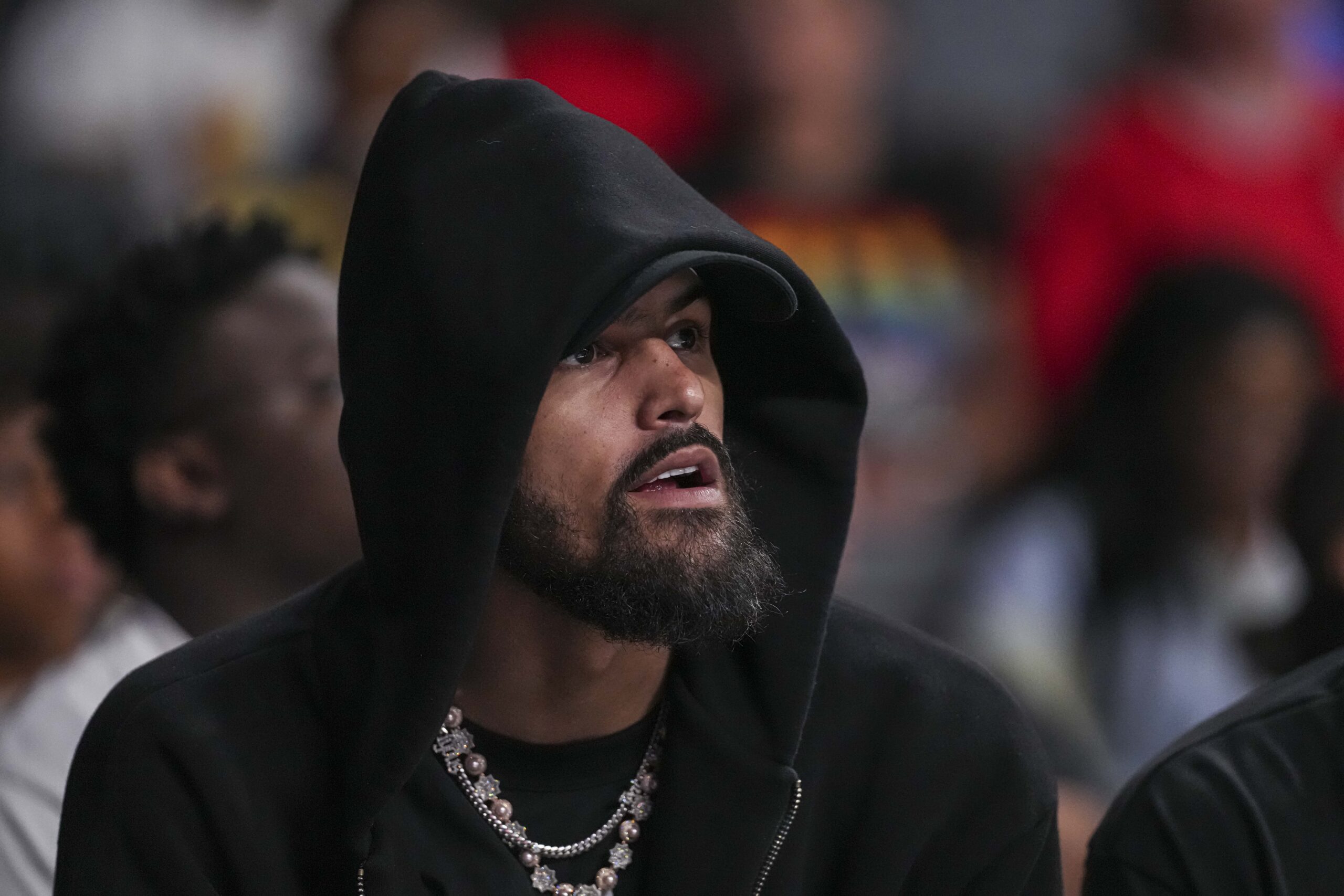 Jun 27, 2025; College Park, Georgia, USA; Atlanta Hawks player Trae Young watches the game between the Atlanta Dream against the Minnesota Lynx during the first half at Gateway Center Arena at College Park