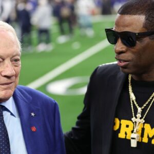 Colorado Buffaloes head coach Deion Sanders (right) talks with Dallas Cowboys owner Jerry Jones before the game against the Seattle Seahawks at AT&T Stadium.
