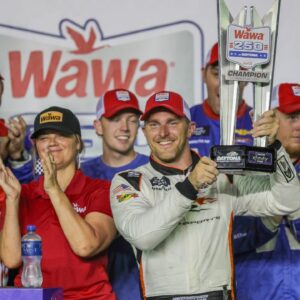 NASCAR Xfinity Series driver Parker Kligerman (88) holds the trophy in Victory Lane after winning the Wawa 250 at Daytona International Speedway.