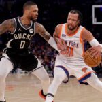 New York Knicks guard Jalen Brunson (11) controls the ball against Milwaukee Bucks guard Damian Lillard (0) during the first quarter at Madison Square Garden