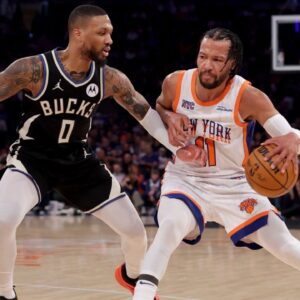 New York Knicks guard Jalen Brunson (11) controls the ball against Milwaukee Bucks guard Damian Lillard (0) during the first quarter at Madison Square Garden