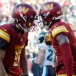 Washington Commanders quarterback Jayden Daniels (5) celebrates with Commanders wide receiver Terry McLaurin (17) after connecting on a touchdown pass against the Philadelphia Eagles during the second quarter at Northwest Stadium.