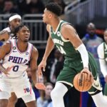 Milwaukee Bucks forward Giannis Antetokounmpo (34) dribbles the ball against Philadelphia 76ers guard Tyrese Maxey (0) in the second half at Fiserv Forum.