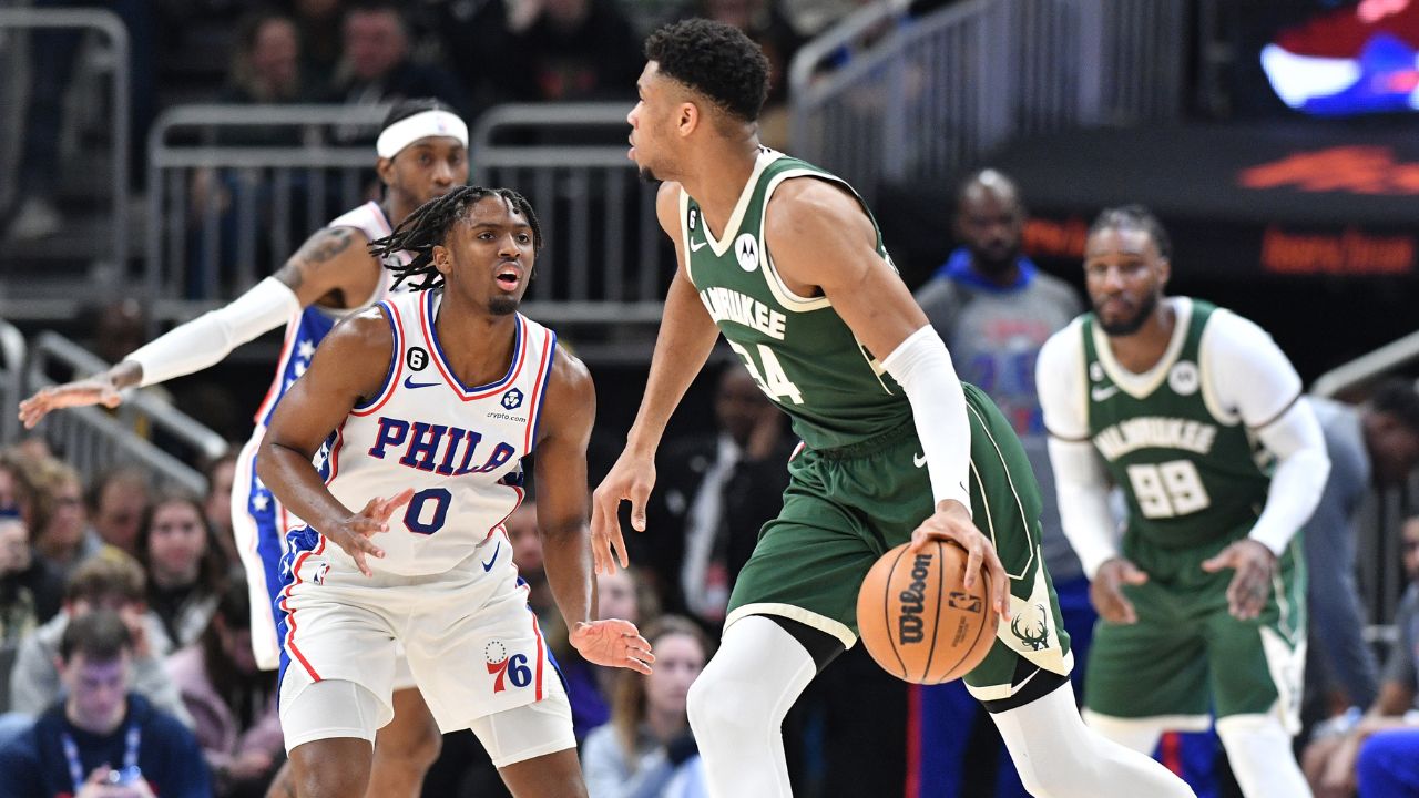 Milwaukee Bucks forward Giannis Antetokounmpo (34) dribbles the ball against Philadelphia 76ers guard Tyrese Maxey (0) in the second half at Fiserv Forum.