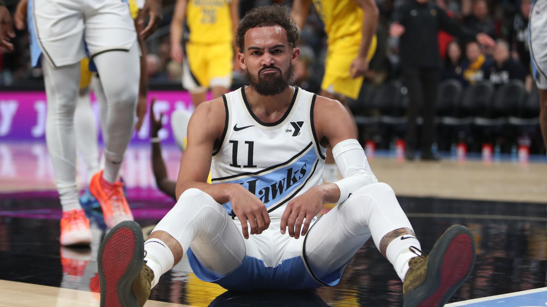 Mar 8, 2025; Atlanta, Georgia, USA; Atlanta Hawks guard Trae Young (11) sits on the court after being fouled by Indiana Pacers forward Pascal Siakam (43) during the first quarter at State Farm Arena
