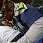 Seattle Seahawks running back Marshawn Lynch (left) kisses his mother Delisa Lynch (right) after the 2013 NFC Championship football game against the San Francisco 49ers at CenturyLink Field.
