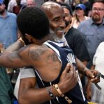 Dallas Mavericks guard Kyrie Irving (11) embraces his father Drederick Irving after the win against the Minnesota Timberwolves in game three of the western conference finals for the 2024 NBA playoffs at American Airlines Center.