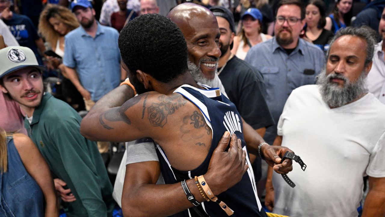 Dallas Mavericks guard Kyrie Irving (11) embraces his father Drederick Irving after the win against the Minnesota Timberwolves in game three of the western conference finals for the 2024 NBA playoffs at American Airlines Center.
