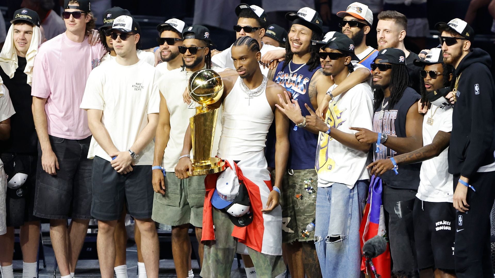 Jun 24, 2025; Oklahoma City, OK, USA; Oklahoma City Thunder guard Shai Gilgeous-Alexander (2) holds the Larry OíBrien Championship Trophy with the team behind him during the Champions Opening Ceremony for the parade inside the Paycom Center.