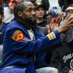 Former Chicago Bulls player Pat Beverley, left, is seen with his son, Elijah Beverly, courtside during the second half of thegame between the Chicago Bulls and the LA Clippers at the United Center.