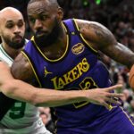 Caption: Mar 8, 2025; Boston, Massachusetts, USA; Los Angeles Lakers forward LeBron James (23) drives to the basket against Boston Celtics guard Derrick White (9) during the first quarter at the TD Garden.
