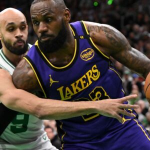 Caption: Mar 8, 2025; Boston, Massachusetts, USA; Los Angeles Lakers forward LeBron James (23) drives to the basket against Boston Celtics guard Derrick White (9) during the first quarter at the TD Garden.