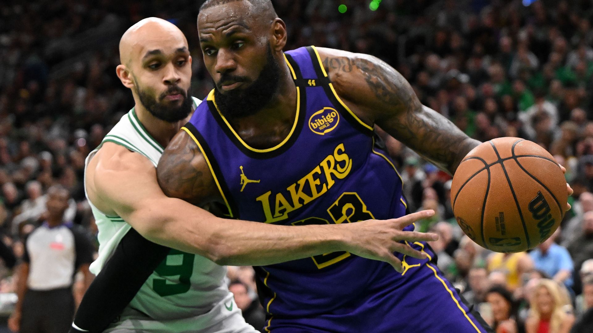 Caption: Mar 8, 2025; Boston, Massachusetts, USA; Los Angeles Lakers forward LeBron James (23) drives to the basket against Boston Celtics guard Derrick White (9) during the first quarter at the TD Garden.