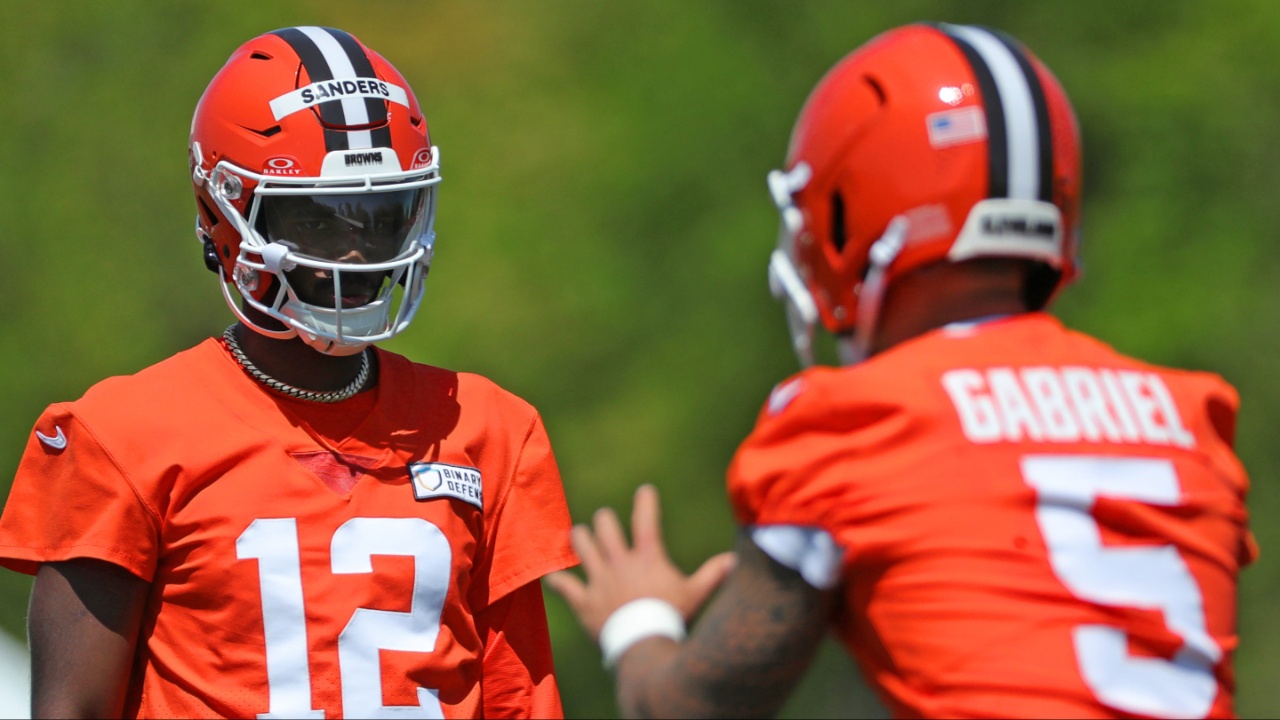 Cleveland Browns quarterback Shedeur Sanders (12) watches quarterback Dillon Gabriel (5) during day two of rookie minicamp May 10, 2025, in Berea, Ohio.