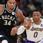 Dec 2, 2022; Milwaukee, Wisconsin, USA; Milwaukee Bucks forward Giannis Antetokounmpo (34) races down the court with Los Angeles Lakers guard Russell Westbrook (0) at Fiserv Forum.