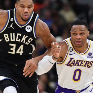 Dec 2, 2022; Milwaukee, Wisconsin, USA; Milwaukee Bucks forward Giannis Antetokounmpo (34) races down the court with Los Angeles Lakers guard Russell Westbrook (0) at Fiserv Forum.