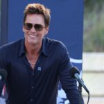 Retired New England Patriot Hall of Famer Tom Brady speaks during a statue unveiling before a game against the Washington Commanders at Gillette Stadium.