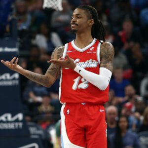 Apr 1, 2025; Memphis, Tennessee, USA; Memphis Grizzlies guard Ja Morant (12) reacts after a basket during the second quarter against the Golden State Warriors at FedExForum.