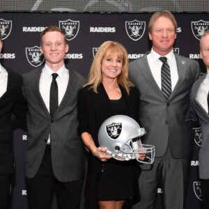Jon Gruden and wife Cindy Gruden pose with sons Deuce Gruden, Michael Gruden and Jon Gruden III pose at press conference after being introduced as Oakland Raiders head coach at the Raiders headquarters.