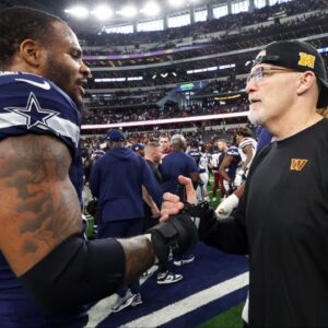 Dallas Cowboys linebacker Micah Parsons (11) speaks with Washington Commanders head coach Dan Quinn after the game at AT&T Stadium.