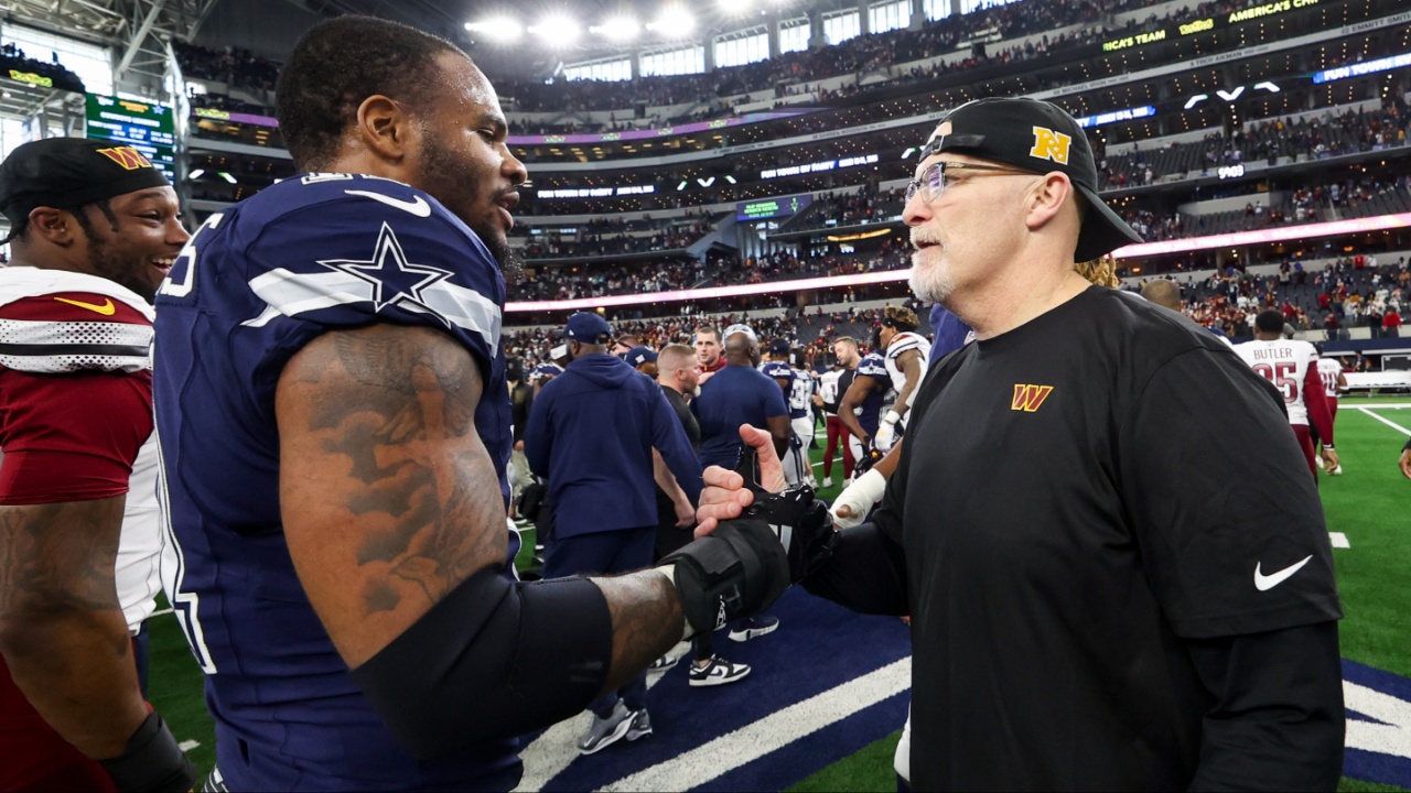 Dallas Cowboys linebacker Micah Parsons (11) speaks with Washington Commanders head coach Dan Quinn after the game at AT&T Stadium.