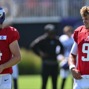 Minnesota Vikings quarterback J.J. McCarthy (9) and quarterback Sam Darnold (14) warm up during practice at Vikings training camp in Eagan, MN.