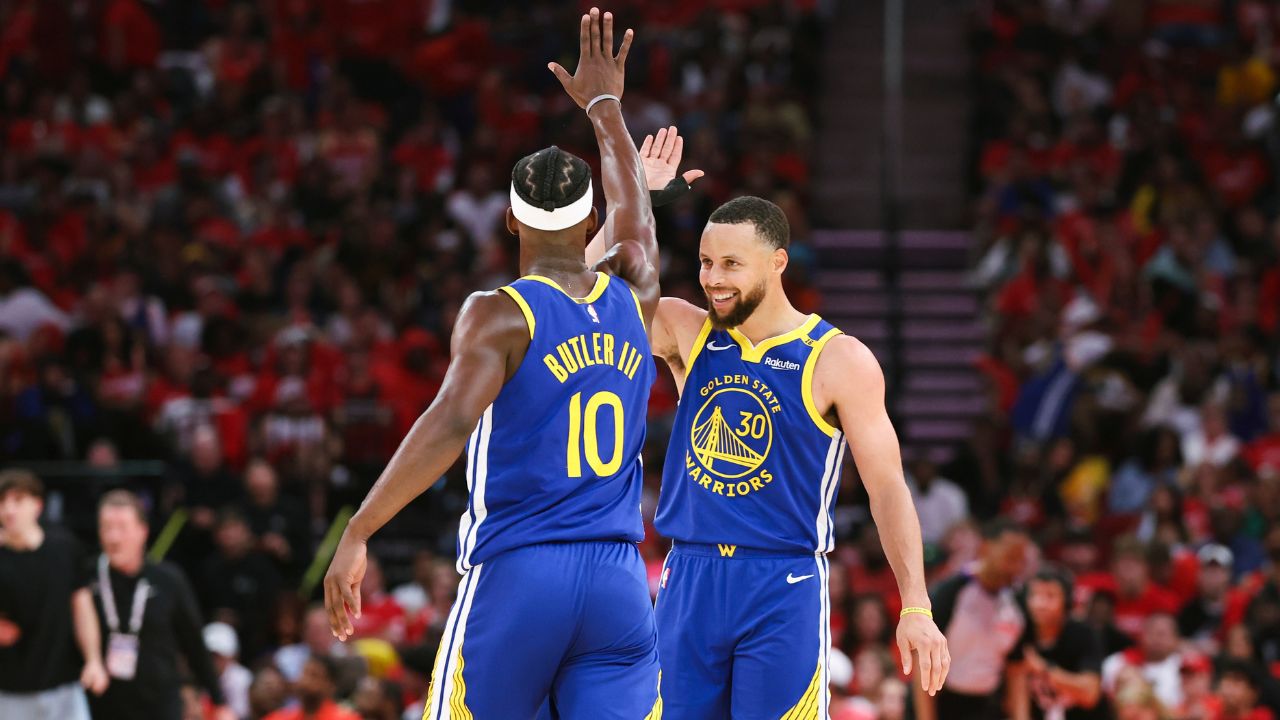 Golden State Warriors guard Stephen Curry (30) celebrates with forward Jimmy Butler III (10) after a play during the third quarter against the Houston Rockets at Toyota Center