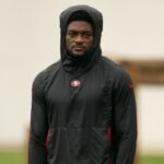 San Francisco 49ers wide receiver Brandon Aiyuk (in black hoodie) watches his teammates work out during the second day of training camp.